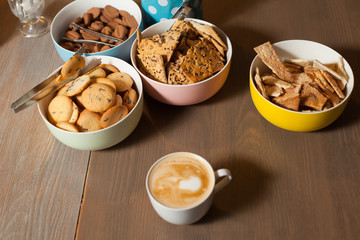 Plates with cookies and cuo on table
