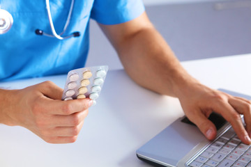 the doctor writes a prescription pill on the computer