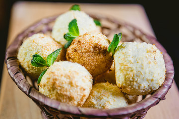 Coconut cookies in a basket with mint, a tasty dessert