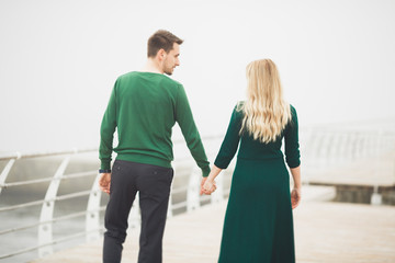 Happy couple on the pier, young family in love spending honeymoon vacation luxury islands