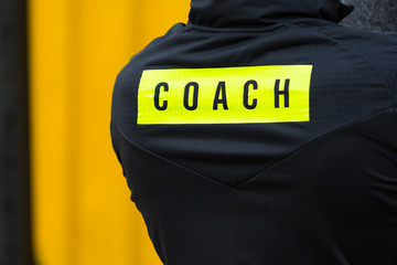 The inscription on the coach sports jacket