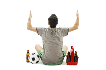 Back view of a excited man with soccer ball and pack of beer looking at wall. Rear view. Isolated on white background
