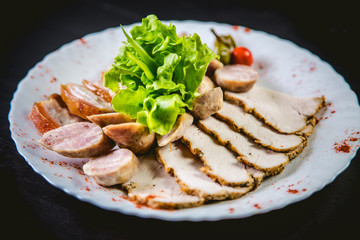 Meat slicing sausages and kebab with salad greens