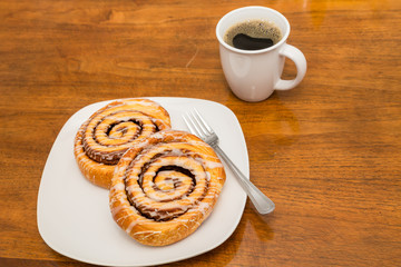 Cinnamon Rolls on Plate with Fork and Coffee