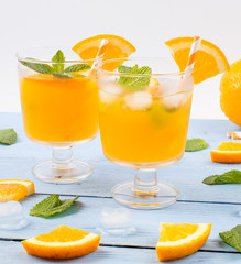 Drink orange with ice in glasses,