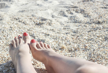 Barefoot feet on sand coast