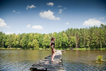 Girl in swimsuit posing at sunset