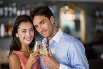Couple toasting glasses of wine