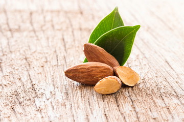 group of almonds on wooden background