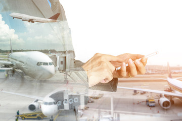 Double exposure of businessman using smart phone on the airport runway background.