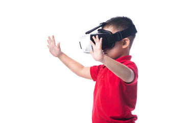 Amazed little asian boy looking in a VR goggles and gesturing wi