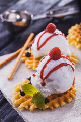 Vanilla Ice Cream with Mint and waffles. Homemade Organic product. On the wooden table.