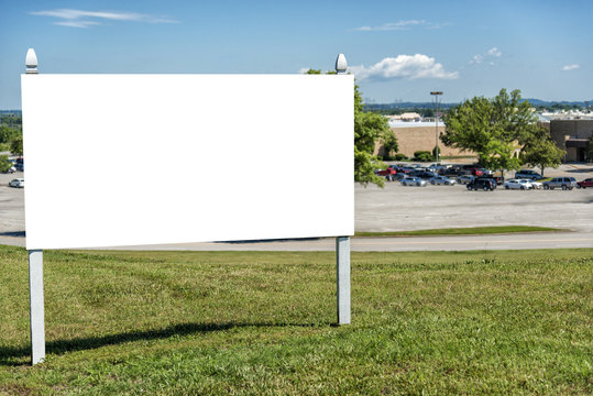 Blank Real Estate Sign In Front Of Retail Complex