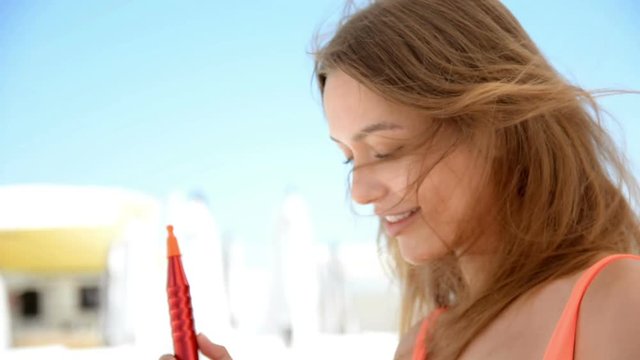 young beautiful girl dancing and smoking hookah at the beach