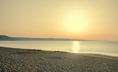 Sunrise on seaside, sand and clear water, the shore of Black Sea