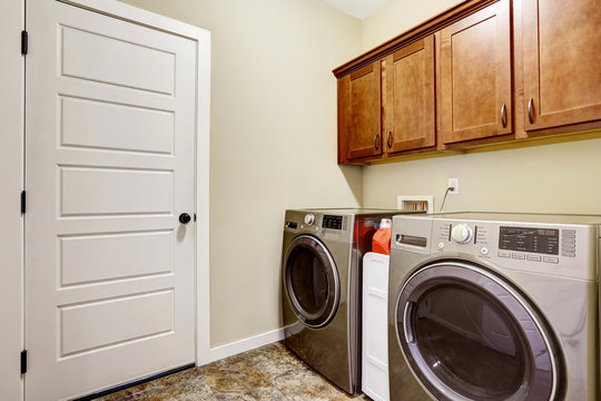  Laundry room with steel appliances and nice cabinets