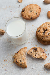 Cookies pile with chocolate chip and almond on light textile background. Delicious morning snacks for breakfast, brunch and lunch. Appetizing, healthy and fast food

