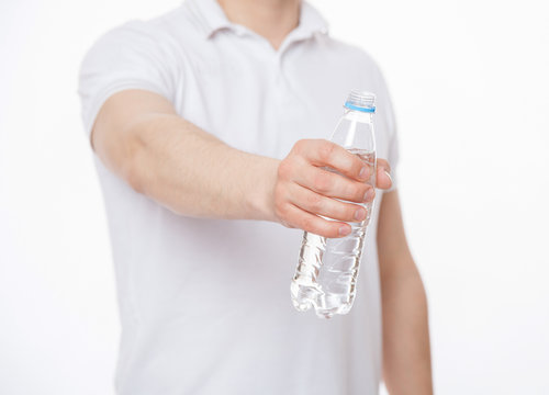 Young Man Giving A Bottle Of Water