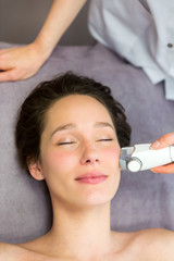 Detail of a woman face receiving a facial massage treatment