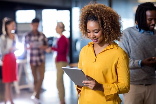 Woman Using Digital Tablet In Office