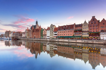 Fototapeta na wymiar Old town of Gdank with reflection in Motlawa river at sunset, Poland