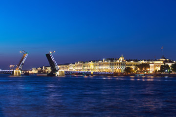 Fototapeta na wymiar Russia, Saint-Petersburg, 02 July 2016: Opening Palace Bridge, a lot of Observing tourists, Neva River at sunrise, Winter Palace, the Hermitage, the Admiralty, a lot ships and boats, long exposure 