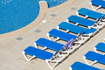 Fototapeta na wymiar beach chairs by the pool