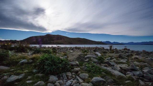 Moon Shine Behind Thick Cloud At Lake Tekapo, New Zealand. Time lapse Pan Left