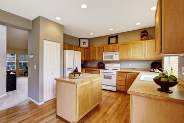 Kitchen interior with brown cabinets, hardwood floor