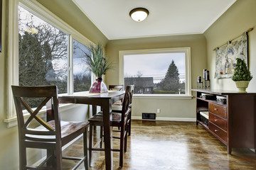 Large green dining room with wooden chairs