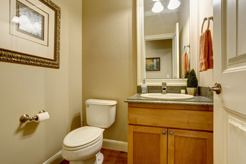 Classic american bathtub with tile floor and wooden cabinets