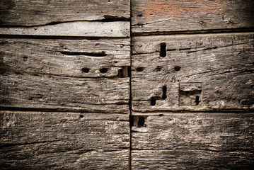 Closeup of an old  wooden antique door with lot of keyholes, grunge rustic background