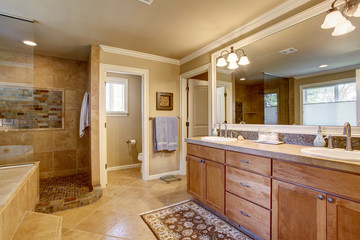 Classic American bathroom with wooden cabinets, two white sinks