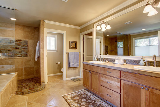 Classic American bathroom with wooden cabinets, two white sinks