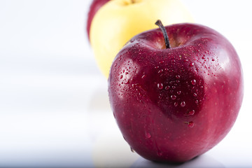 red apple with a yellow apple behind. Health and Nutrition
