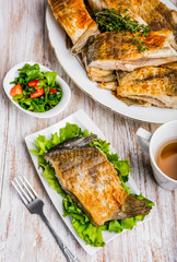 Fried fish with golden crust on a white plate