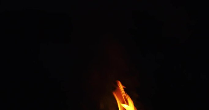 campfire flames dansing over black background