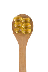 Omega 3 pills on a spoon.