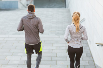 Obraz premium couple running downstairs on city stairs