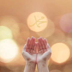 Woman open human hands prayer with palm up and candle night light lantern bokeh with islamic...