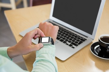 Obraz na płótnie Canvas Man adjusting time on his smartwatch