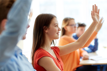 group of students with notebooks at school lesson