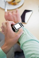 Man adjusting time on his smartwatch