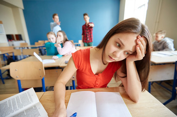 students gossiping behind classmate back at school