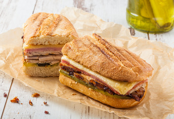Cuban sandwich called Cubanito. Popular latin sandwich with marinated roasted pork, ham, cheese and pickles.