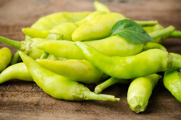 Green chili on wooden background