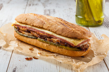 Cuban sandwich called Cubanito. Popular latin sandwich with marinated roasted pork, ham, cheese and pickles.