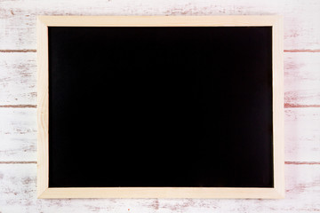 Blank blackboard on wooden table.Template mock up for adding you