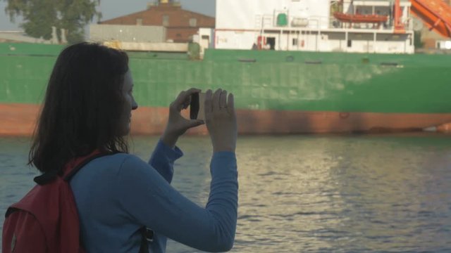 the girl with the phone in port, Russia