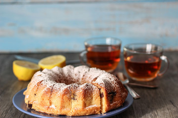 homemade lemon cupcake with chocolate chips and  two cups of tea